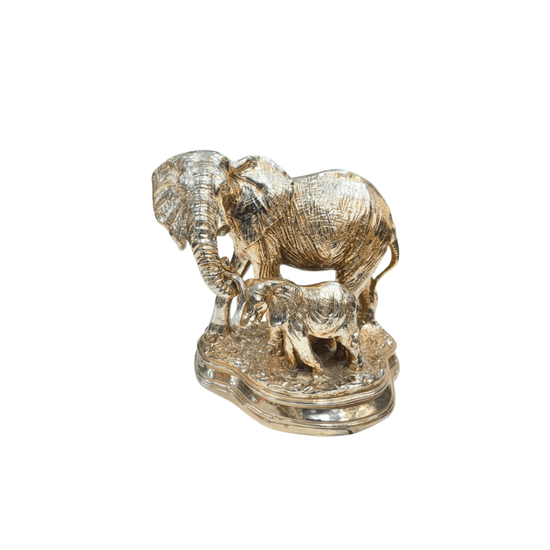 Metallic silver and gold toned Statue of an adult elephant standing next to a baby elephant